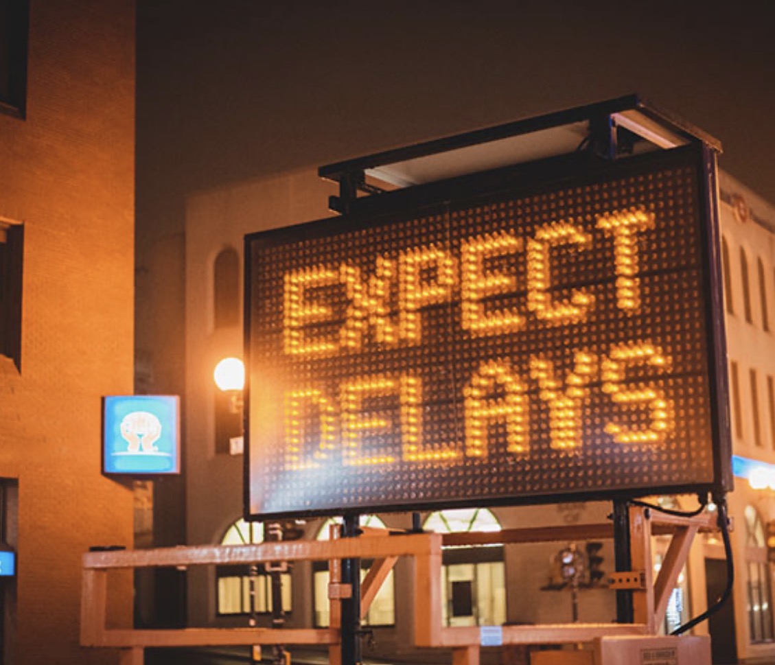 Illuminated portable message sign warning drivers to expect delays